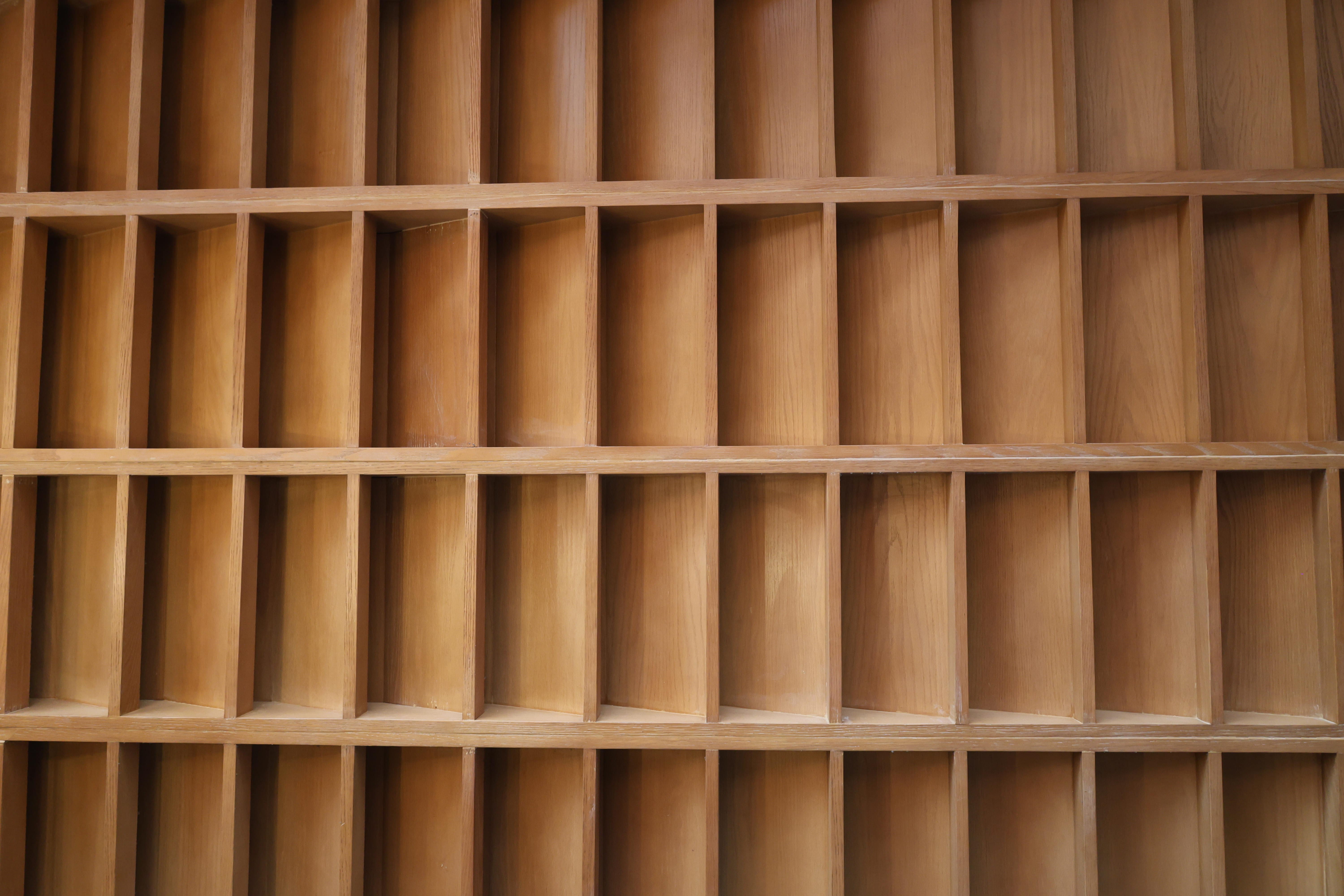Close-up of solid wood wall panel grid showing joinery and finish quality by Reywood Indonesia